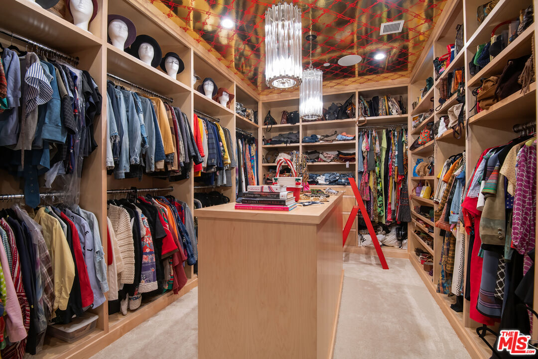 16001 Woodvale Road Encino, CA 91436 - Photo 23 of 49 a view of walk in closet with clothes and shoes