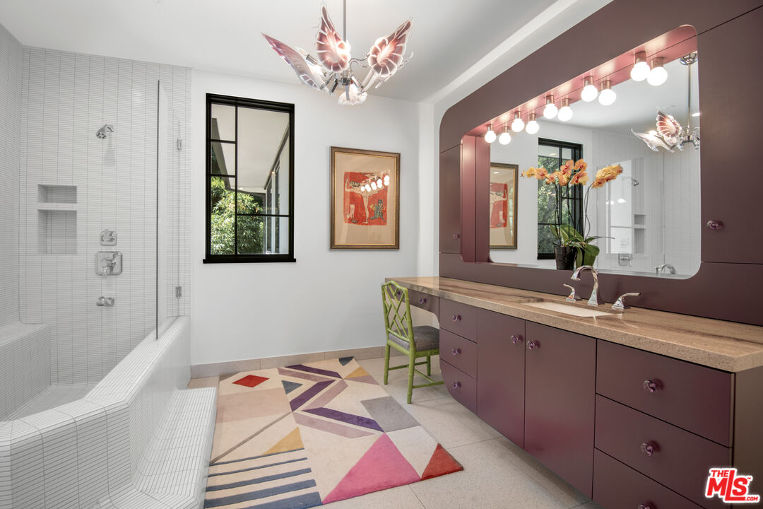 16001 Woodvale Road Encino, CA 91436 - Photo 27 of 49 a spacious bathroom with a tub sink and mirror