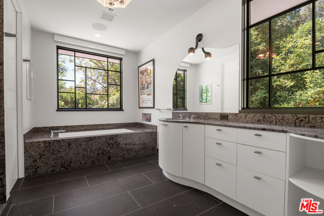 16001 Woodvale Road Encino, CA 91436 - Photo 29 of 49 a bathroom with a bathtub and a sink