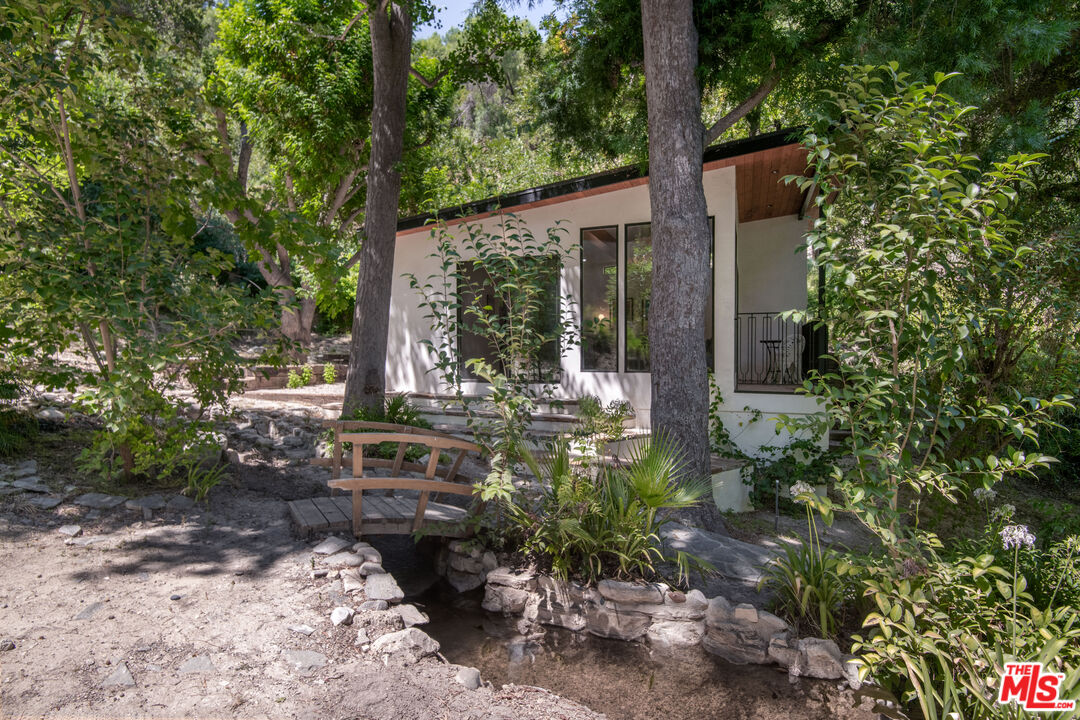 16001 Woodvale Road Encino, CA 91436 - Photo 38 of 49 a front view of a house with garden