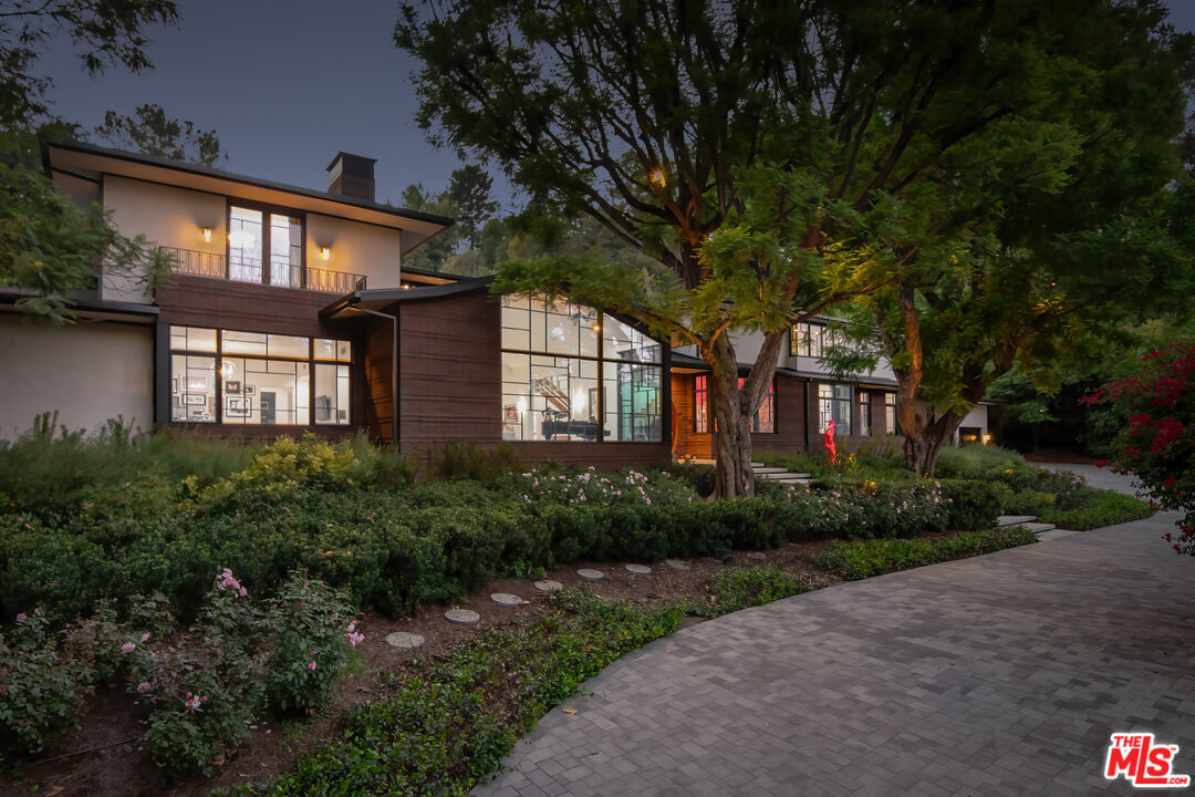 16001 Woodvale Road Encino, CA 91436 - Photo 47 of 49 a front view of a house with garden