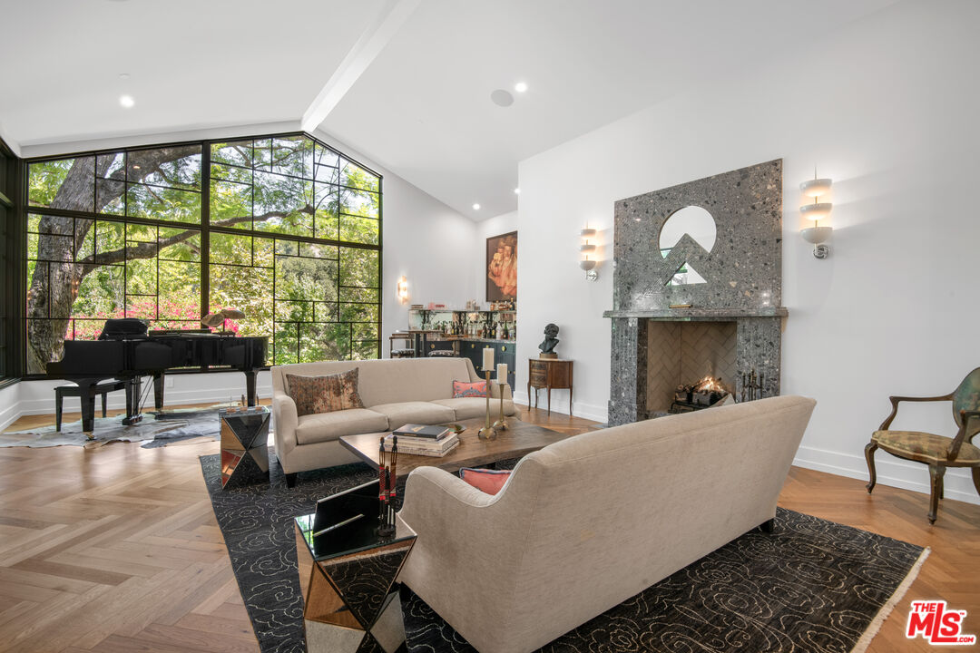 16001 Woodvale Road Encino, CA 91436 - Photo 5 of 49 a living room with furniture and a large window