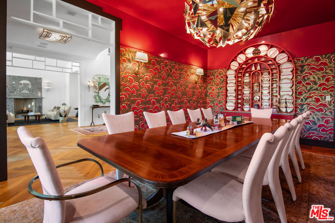 16001 Woodvale Road Encino, CA 91436 - Photo 8 of 49 a living room with a table and chairs with wooden floor