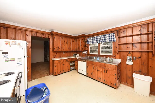a kitchen with stainless steel appliances a refrigerator and a stove top oven