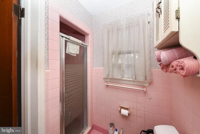 a bathroom with a sink a mirror and toilet