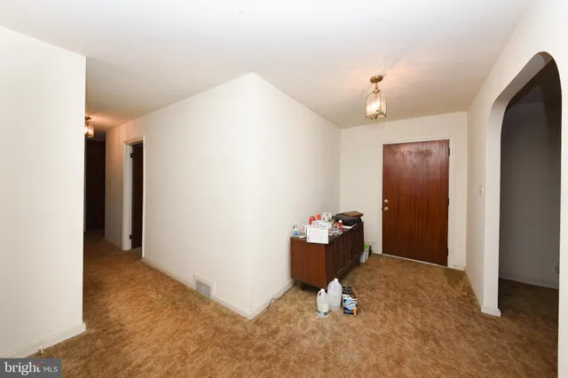 a room with gym equipment and view of living room