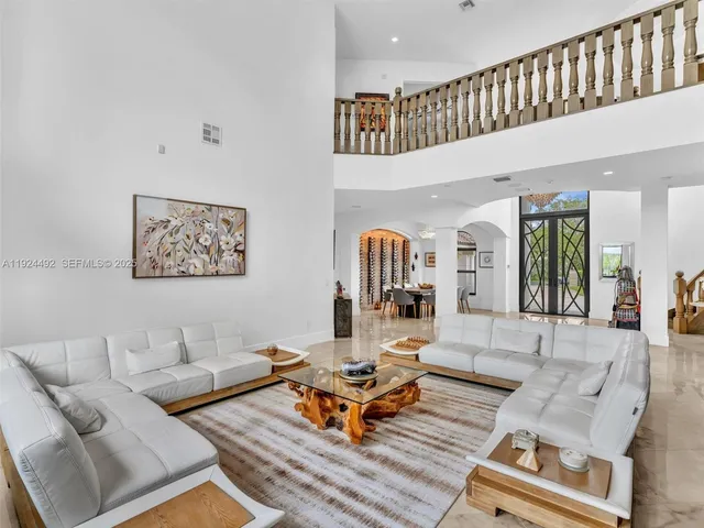 a dining room with furniture a large window and a chandelier