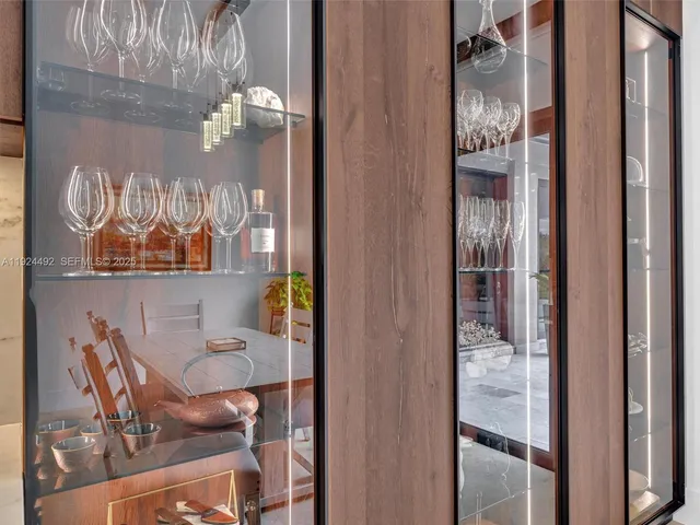 a view of a patio with a table chairs and a floor to ceiling window