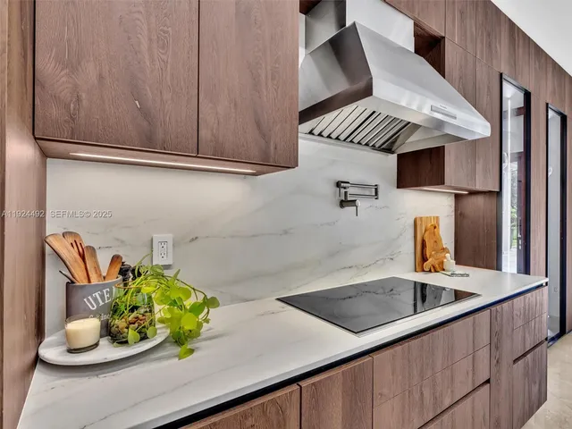 a front view of a house with a garden and plants