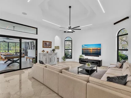a view of a house with swimming pool and sitting area