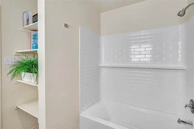 a bathroom with a sink toilet vanity and shower