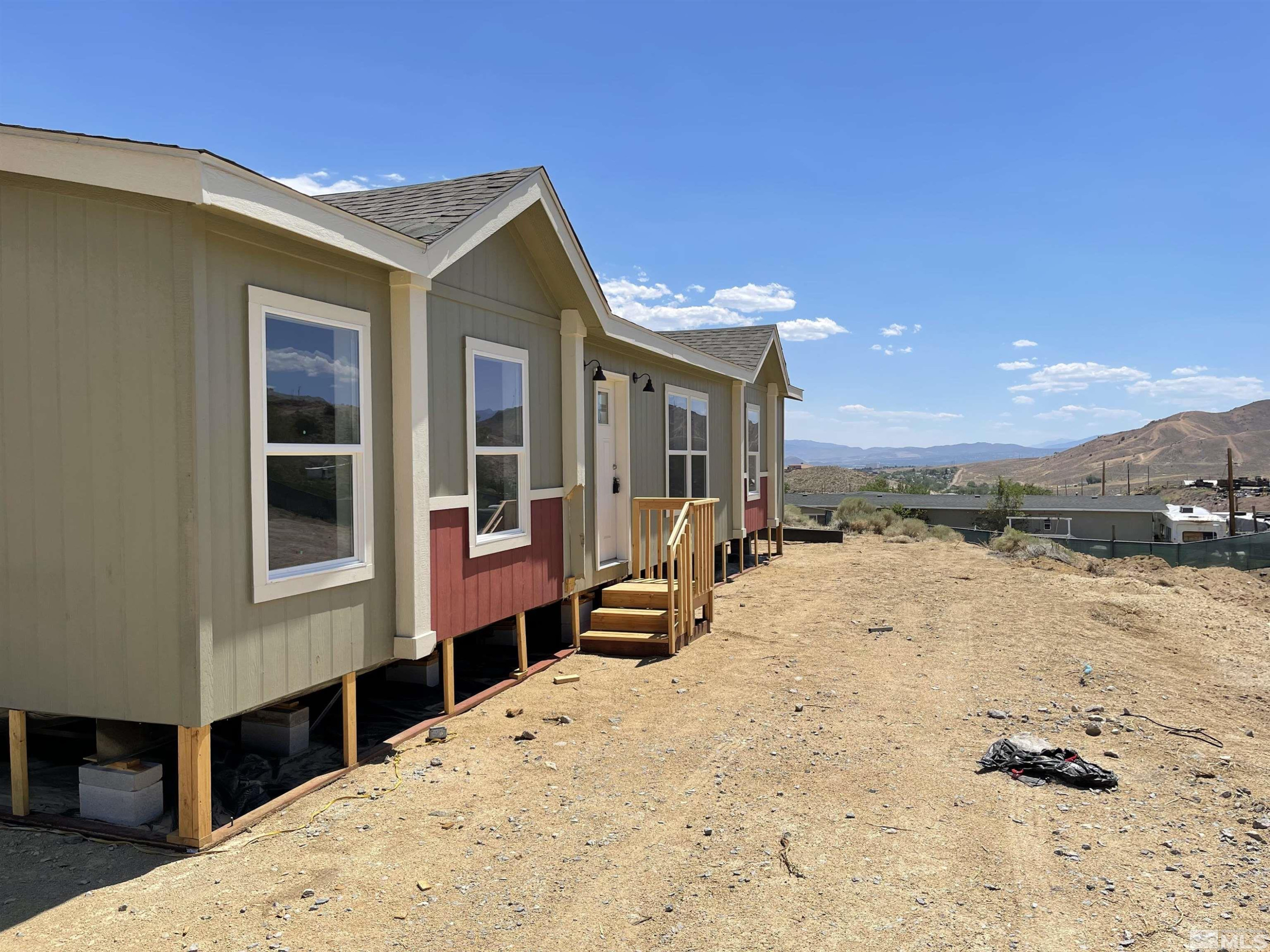 a view of a house with a snow in the background