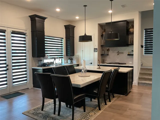 a large kitchen with a table and chairs