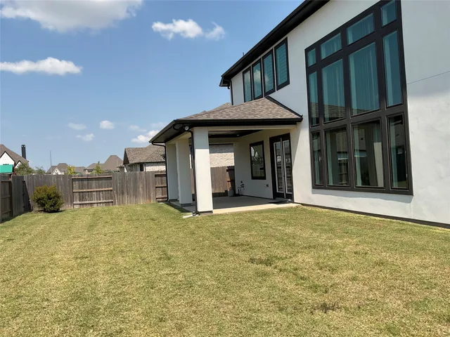 a view of a house with a backyard and porch