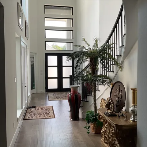 a view of entryway and hall with wooden floor