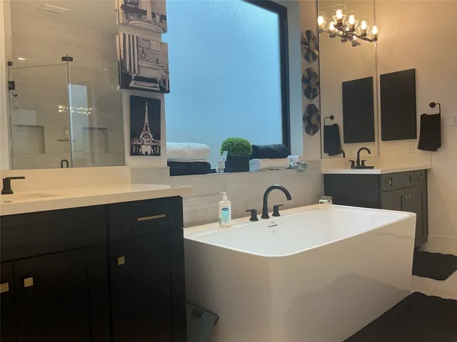 a bathroom with a double vanity sink and mirror
