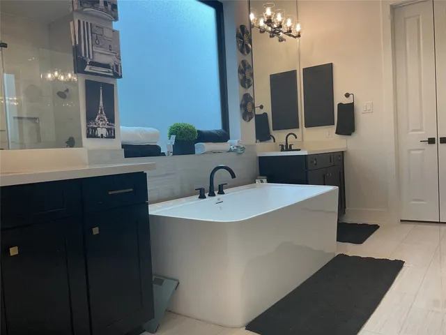 a bathroom with a sink double vanity and mirror
