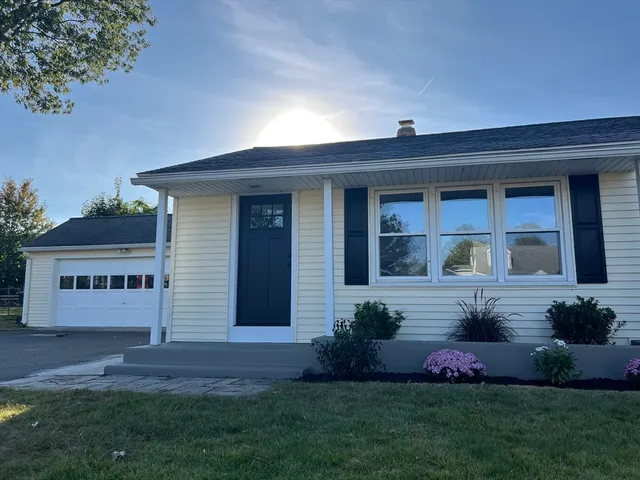 a front view of a house with a garden