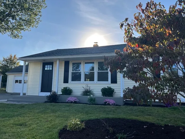 a view of a house with backyard garden and plants