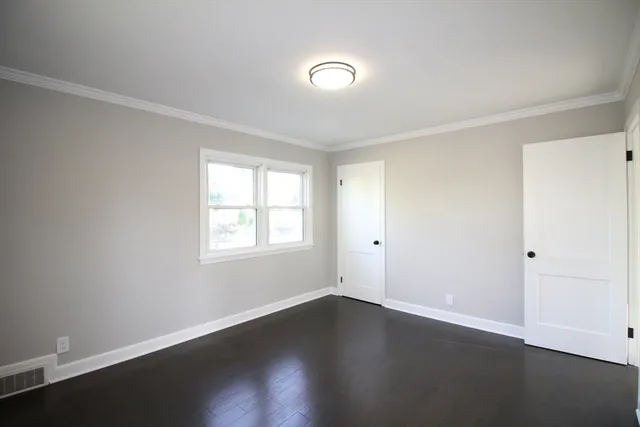 a view of a room with wooden floor and window