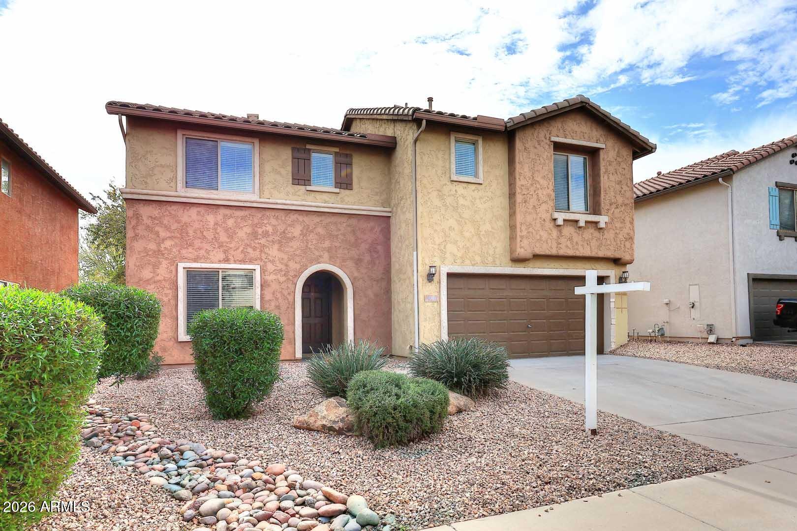 a front view of a house with garden
