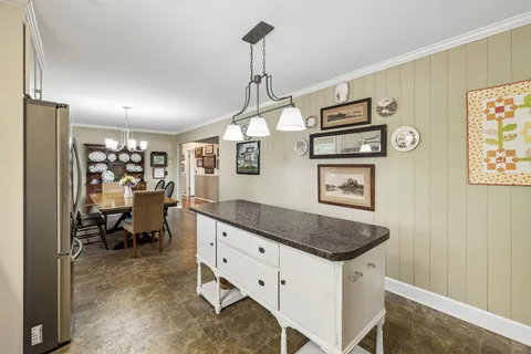 a kitchen with stainless steel appliances granite countertop a stove a refrigerator and a sink