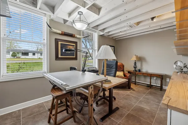 a view of a hallway with wooden floor and a window