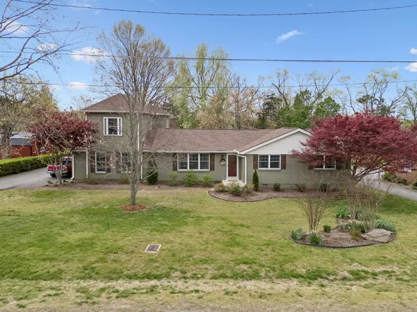 a kitchen with granite countertop a sink stove and refrigerator