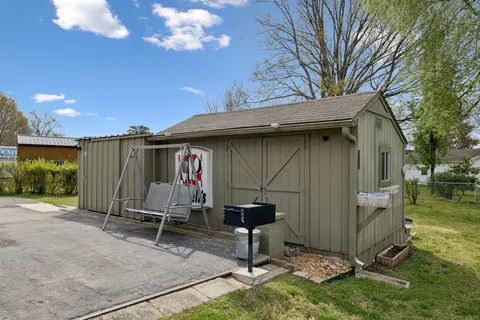 a view of a house with a yard and plants