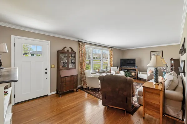 a dining room with furniture a chandelier and window
