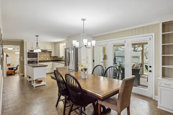 a kitchen with stainless steel appliances granite countertop a sink a stove and refrigerator