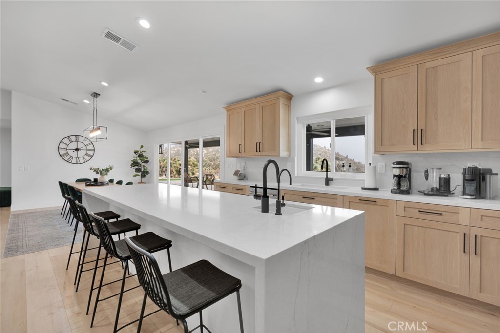 a kitchen with a dining table chairs and white cabinets