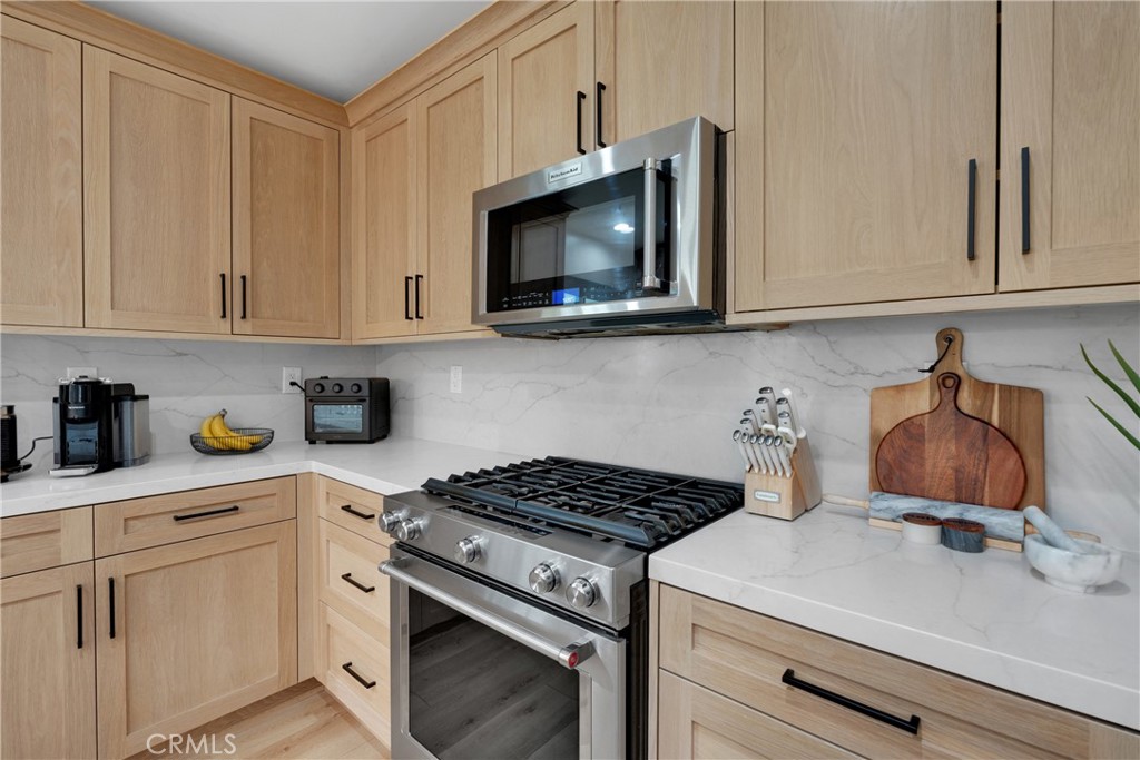 2128 Pheasant Road Wrightwood, CA 92397 - Photo 15 of 52 a kitchen with stainless steel appliances granite countertop white cabinets and a stove a oven with white countertops