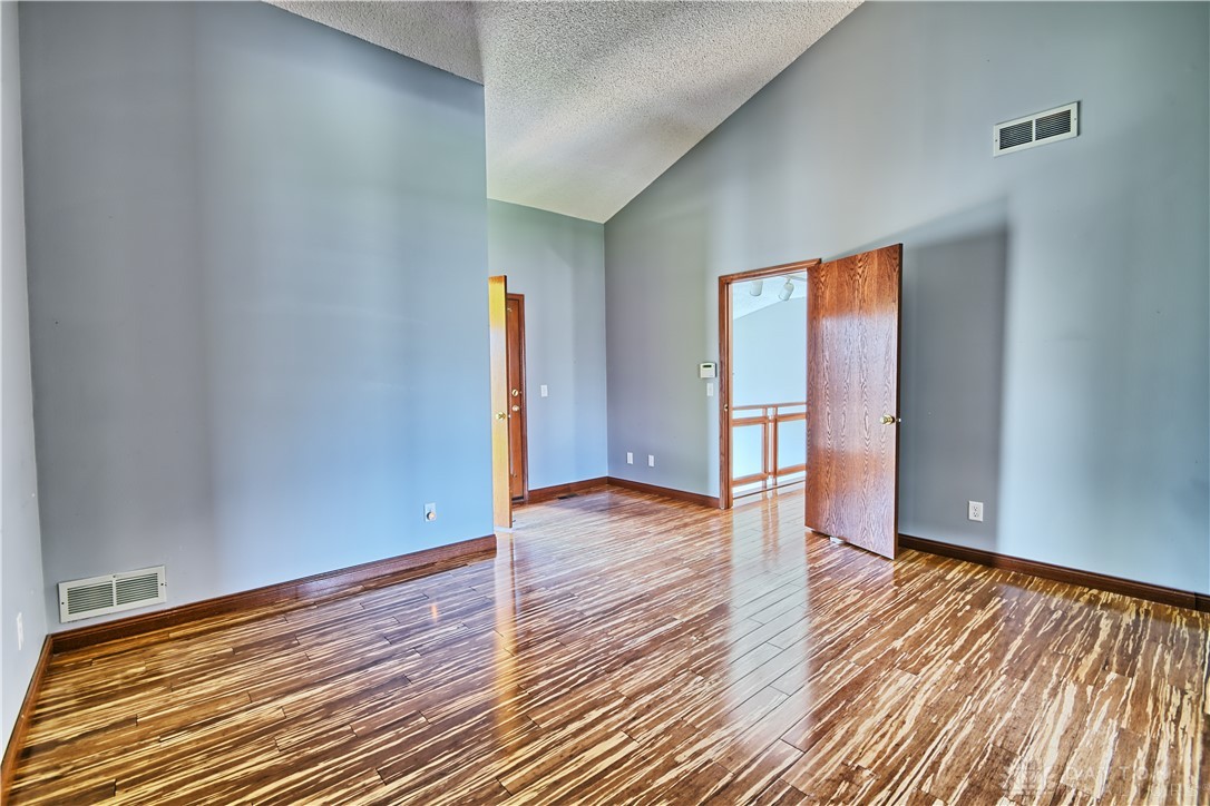 8711 Nicole Lane Springboro, OH 45066 - Photo 40 of 87 This interior space features vaulted ceilings and rich wood flooring, ready for your personal touch.