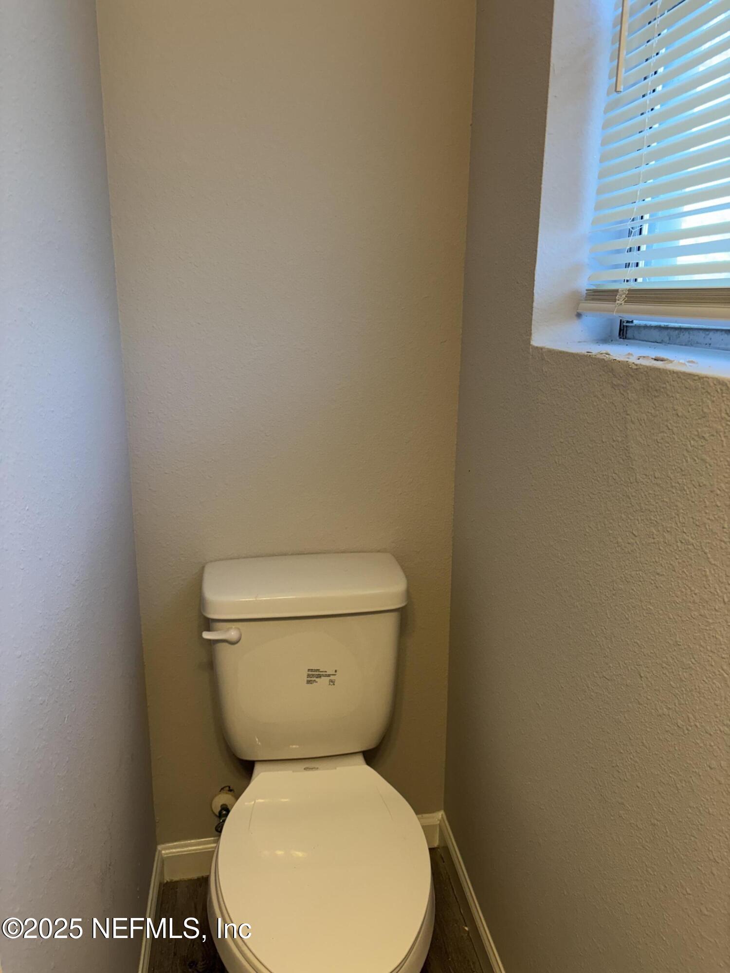 4444 Rainer Road Jacksonville, FL 32210 - Photo 12 of 19 a white toilet sitting next to a window