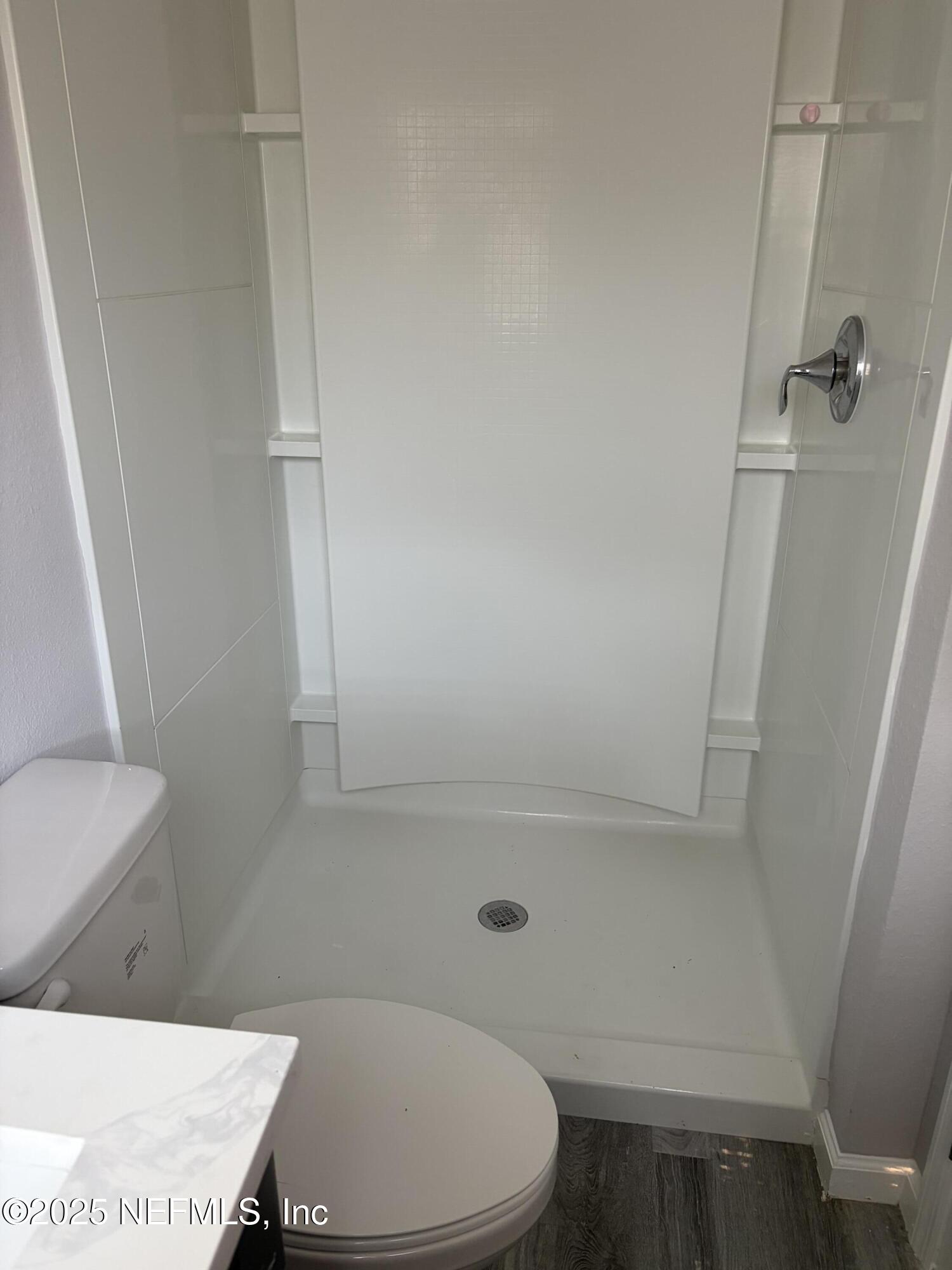 4444 Rainer Road Jacksonville, FL 32210 - Photo 15 of 19 a bathroom with a sink a toilet and a shower