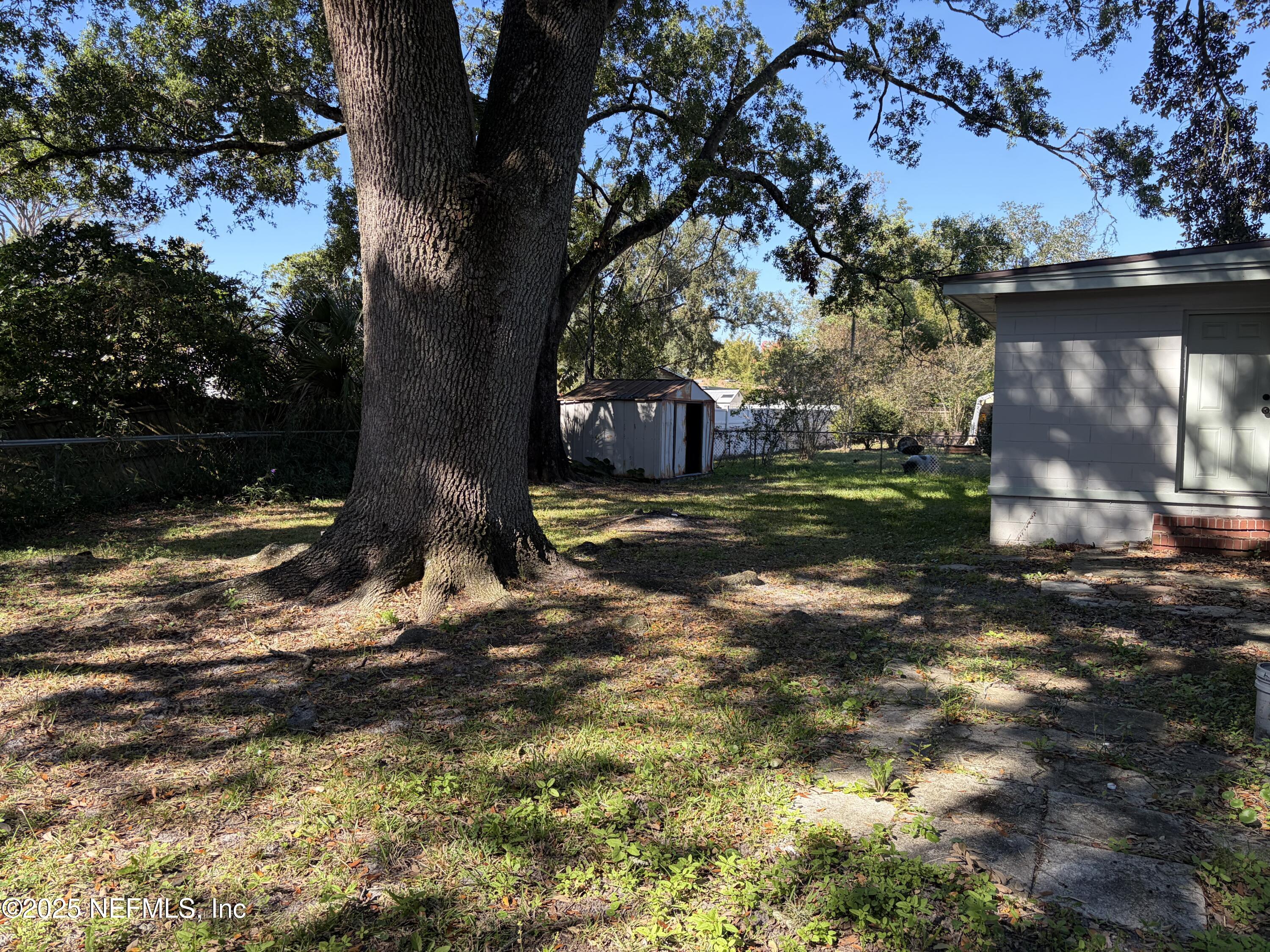 4444 Rainer Road Jacksonville, FL 32210 - Photo 18 of 19 a view of a backyard with large trees
