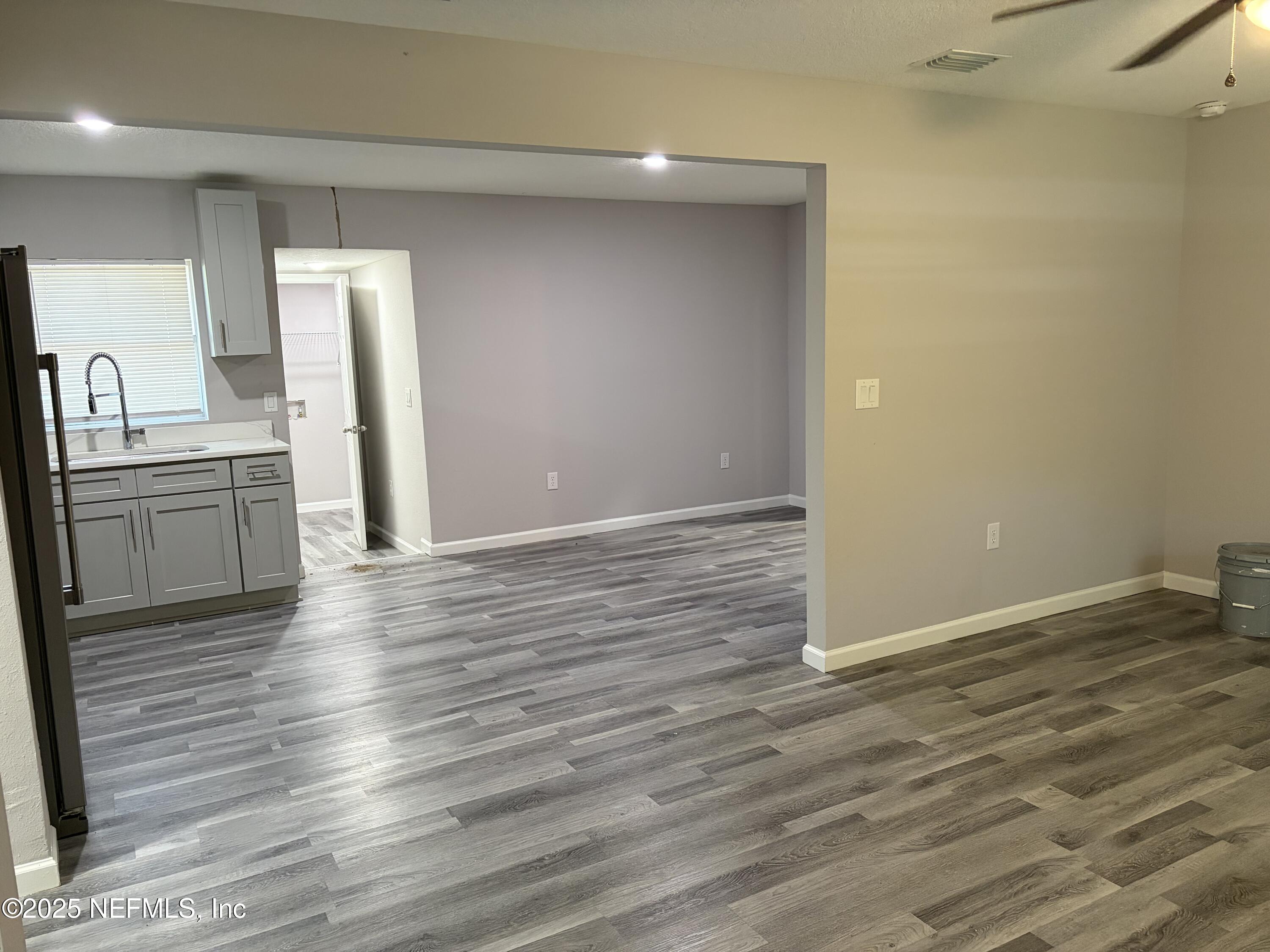 4444 Rainer Road Jacksonville, FL 32210 - Photo 3 of 19 a view of a kitchen with a sink and a refrigerator