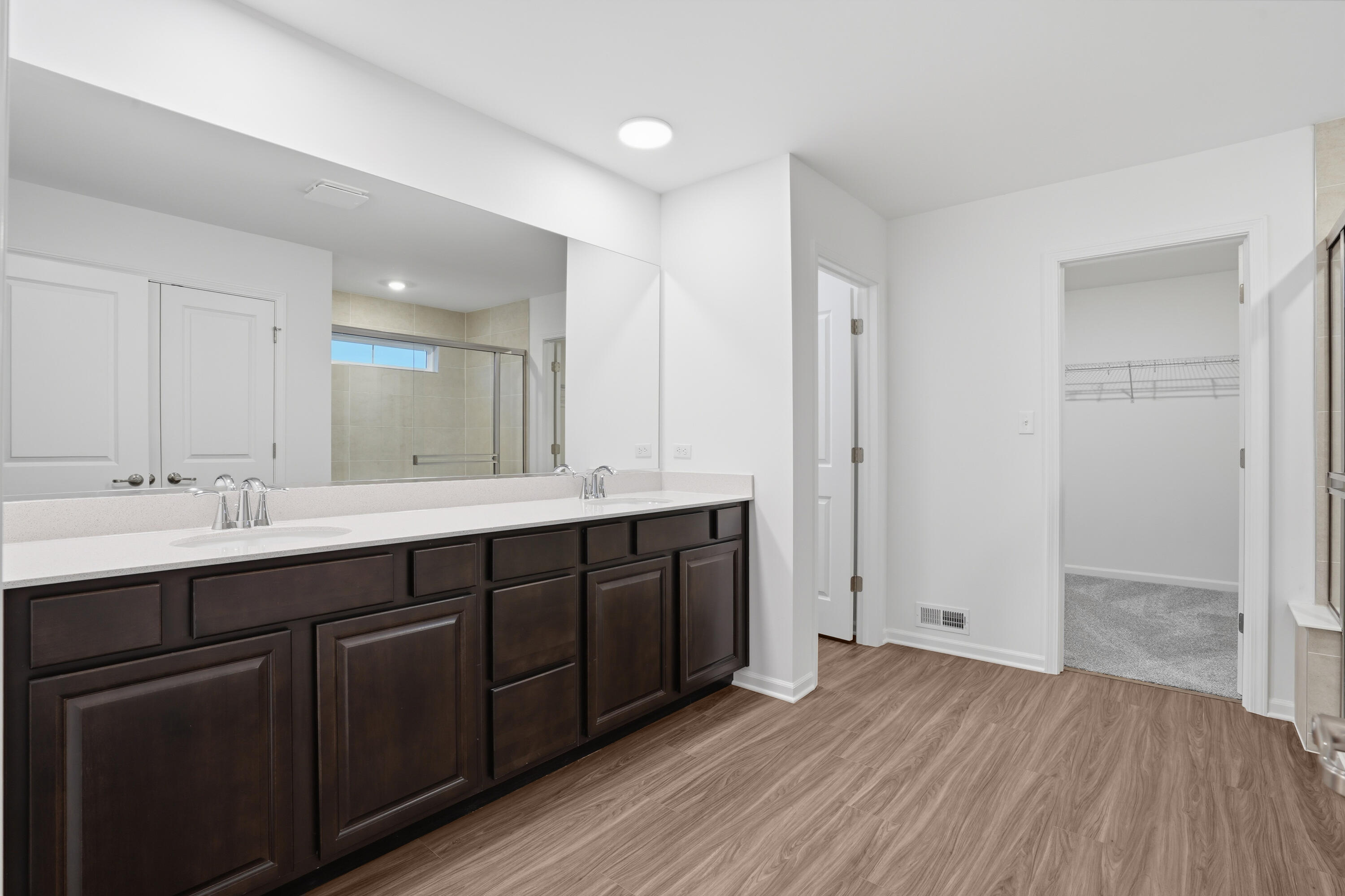5970 East 112th Place Winfield, IN 46307 - Photo 12 of 57 a bathroom with a double vanity sink and a mirror