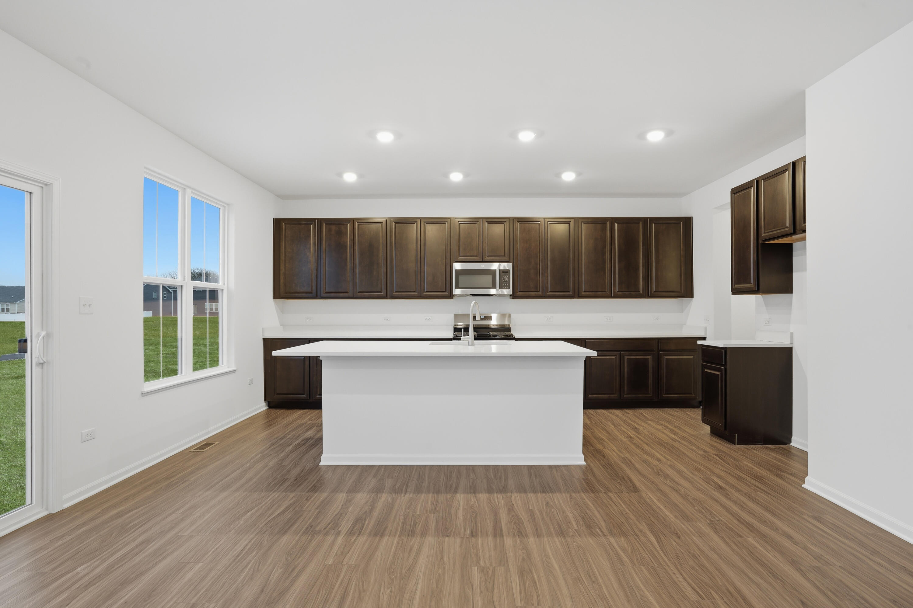 5970 East 112th Place Winfield, IN 46307 - Photo 2 of 57 a living room with stainless steel appliances kitchen island hardwood floor sink stove and wooden floor