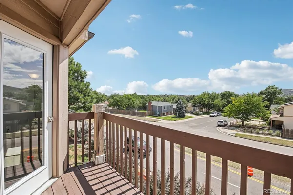 a view of a balcony with wooden floor