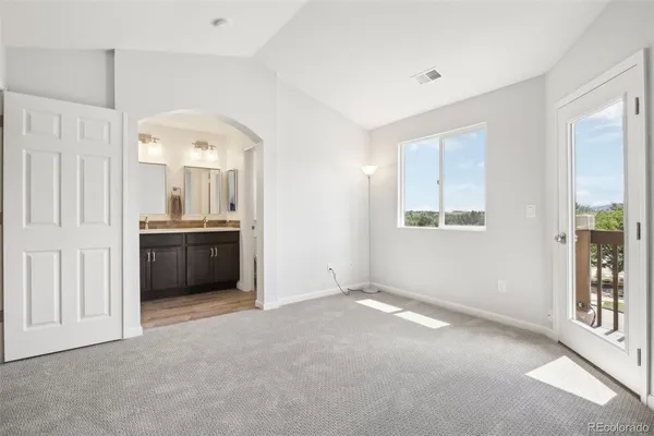 an empty room with windows and closet