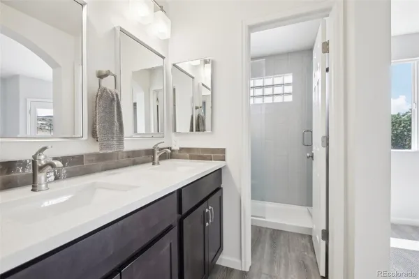 a bathroom with a double vanity sink a and mirror