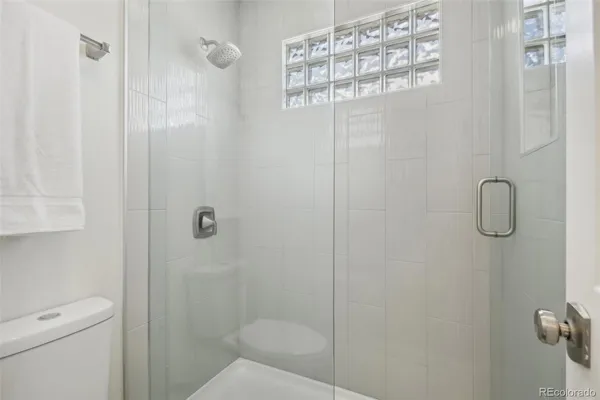 a bathroom with a shower toilet and sink