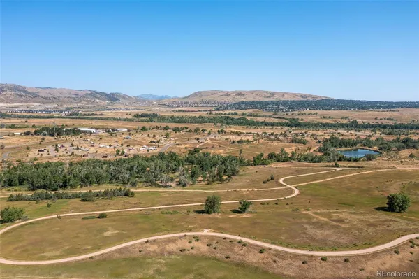 a picture of a bench in front of a white house
