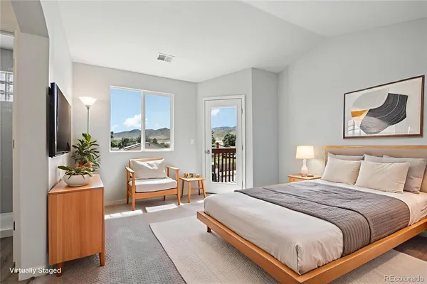 a bedroom with a bed and a couch