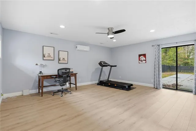 a work room with furniture and a floor to ceiling window