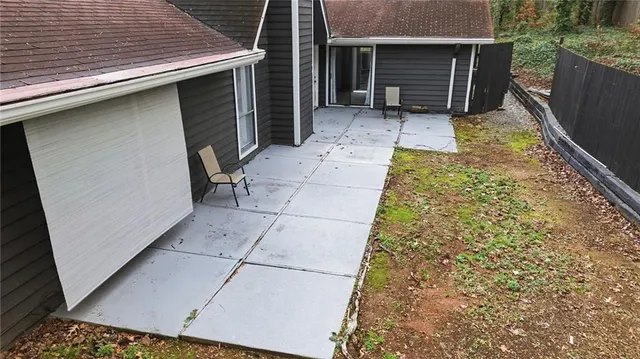 front view of a house with a large tree