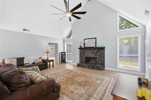 a living room with furniture a fireplace and a flat screen tv