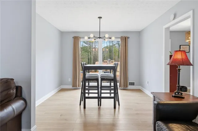 a dining room with furniture and wooden floor